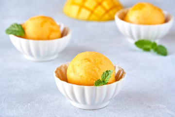 Mango ice cream sorbet with mint leaves and mango fruit
