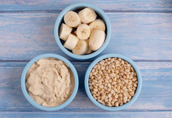 ingredients for making smoothies in bowls - banana, hummus and pine nuts