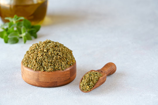 Mixed spice zaatar or zatar in wooden bowl  and olive oil
