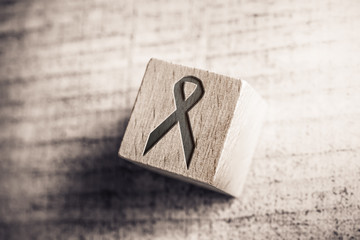 Black Death And RIP Ribbon On A Wooden Block On A Table
