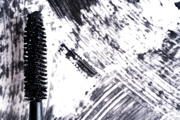The texture of mascara and black strokes or acrylic on a white background. Brush of mascara. Black smears.