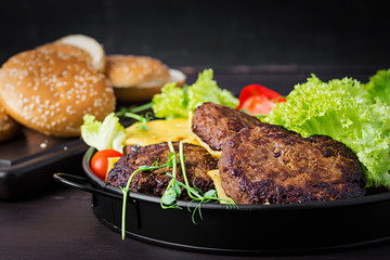 Burger cooking - burger with beef,  tomato, cheese, pickled cucumber and red onion on plate