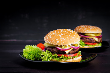 Big sandwich - hamburger burger with beef,  tomato, cheese, pickled cucumber and red onion.