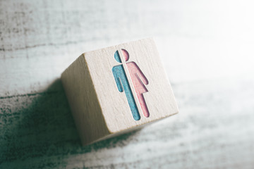Gender Signs For Male And Female Cut In Half On A Wooden Block On A Table