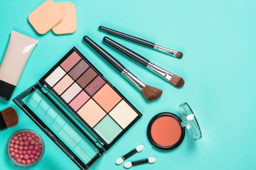 Makeup professional cosmetics on mint background.