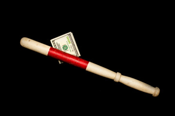 vintage old police index stick with corruption dollars, front and background blurred