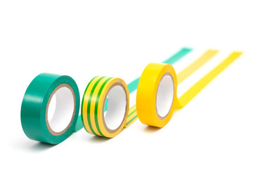 Rolls of insulation adhesive tape, multi colored ribbons on a white background.
