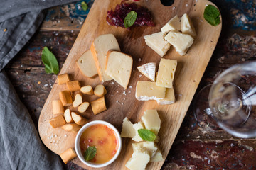 Cheese Plate Served with Onion Marmalade and Honey. Rustic Background