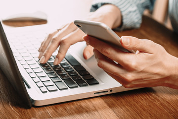 Woman working at home office hand on keyboard close up