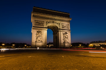 Fototapeta na wymiar The Arc de Triomphe de l'Étoile illuminated at night, Paris