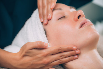 Fototapeta na wymiar Woman Receiving Facial Fitness Lifting Massage