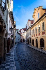 Fototapeta na wymiar Narrow Alley With Old Houses In The Old Town Of Prague In The Czech Republic