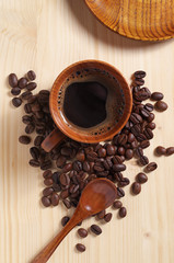 Cup of hot coffee and beans