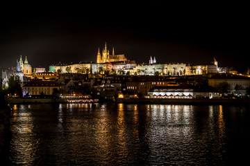 Fototapeta na wymiar Illuminated Saint Vitus Cathedral, Hradcany Castle And River Moldova In The Night In Prague In The Czech Republic