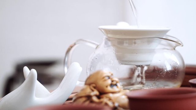 Close-up of the Chinese tea ceremony gaiwan and pour in a delicious flavored tea through a sieve
