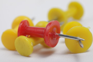 Colored thumb tack on a white background