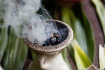 Incense burner with green leaves