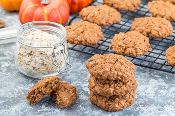 Spicy pumpkin and oatmeal cookies on the table and on  cooling rack, horizontal