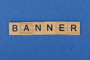 word banner of brown wooden letters lies on a blue table