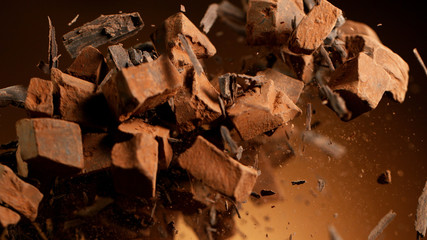 Flying pieces of crushed chocolate pieces