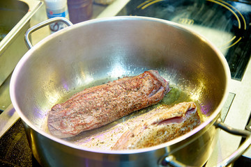 Chef fries beef tenderloin with roast beef pepper