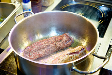 Chef fries beef tenderloin with roast beef pepper