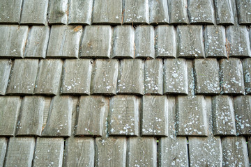 wooden handmade aged and weathered tiles on roof texture background. Wooden rough pattern