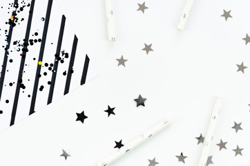 New Year or Christmas geometric black and white pattern flat lay top view 2020 celebration drinking cocktail party straws, stripes and silver star sparkles background