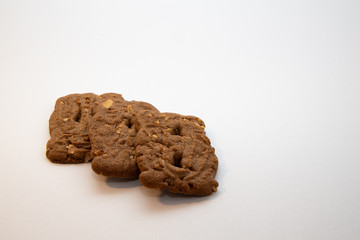 Typical Dutch cookies (spiced bisquits called Speculaas) on a white surface.