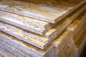 OSB sheets stacked in a hardware store. Construction material