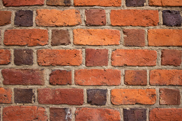Background, bright red brick wall of an old building. Brick textured masonry