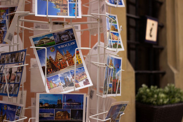 Wroclaw, Poland - October 31, 2019. Postcards depicting Wroclaw sights on a metal rack in the city center. Purchase of postcards by memory