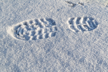 Imprint of shoes in the snow. Single clearly defined footprint of a shoe or boot in snow.