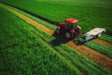 Tractor mowing green field