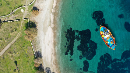 Aerial drone top down photo of traditional fishing boat near famous beach of Vagia, Serifos island, Cyclades, Greece