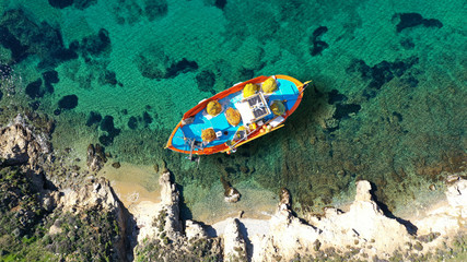 Fototapeta na wymiar Aerial drone top down photo of traditional fishing boat near famous beach of Vagia, Serifos island, Cyclades, Greece