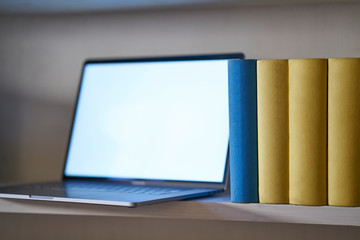 Close up of laptop in bookshelf