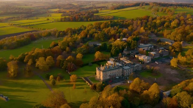 Aerial footage of Autumn Fall colours at Sunset around a Bretton Hall, a beautiful Georgian Country House near Wakefield, UK