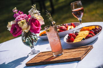 Wedding table with pink cocktail and flowers