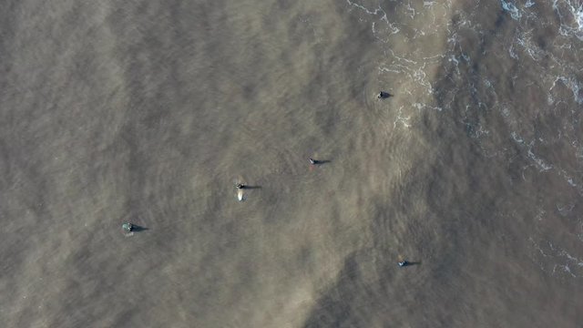 Aerial view of sufers waiting for wave at dunraven bay
