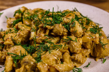 Champignons stewed in sour cream on a plate