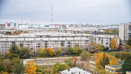 School stadium inside a block of old apartment buildings against the backdrop of a television tower. Sleeping urban areas. Autumn