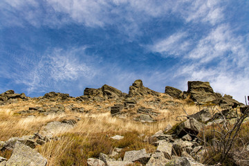 Fototapeta na wymiar United Kingdom highland rocky mountain ridge scenery landscape with sharp edges stone on top and cloudy blue sky background 