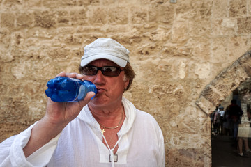 A Mature male tourist inspects an ancient castle