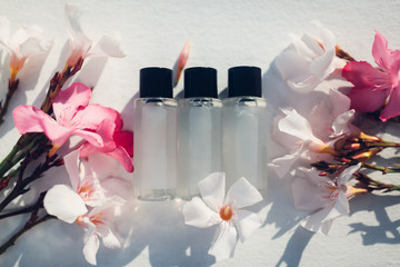 Natural cosmetics. Lotion bottles with oleander flowers. Skin care organic medicine