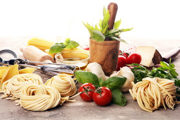 Pasta, vegetables, herbs and spices for Italian food on rustic table