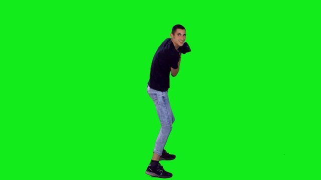 Teenage boy play an intense VR game and drops his headset to the floor. Full shot over green screen.