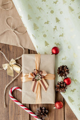Fototapeta na wymiar Christmas presents with ribbon on dark wooden background in vintage style