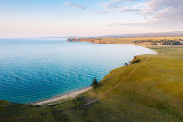 Aerial view of Lake Baikal and coastline of Olkhon Island at sunset. Nature landscape in Siberia, Russia