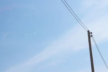 Electric pole with sky background.